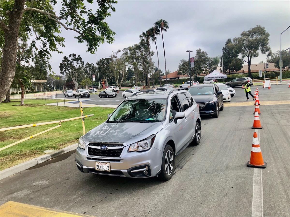 cars lined up for drive thru at Costa Mesa compost event